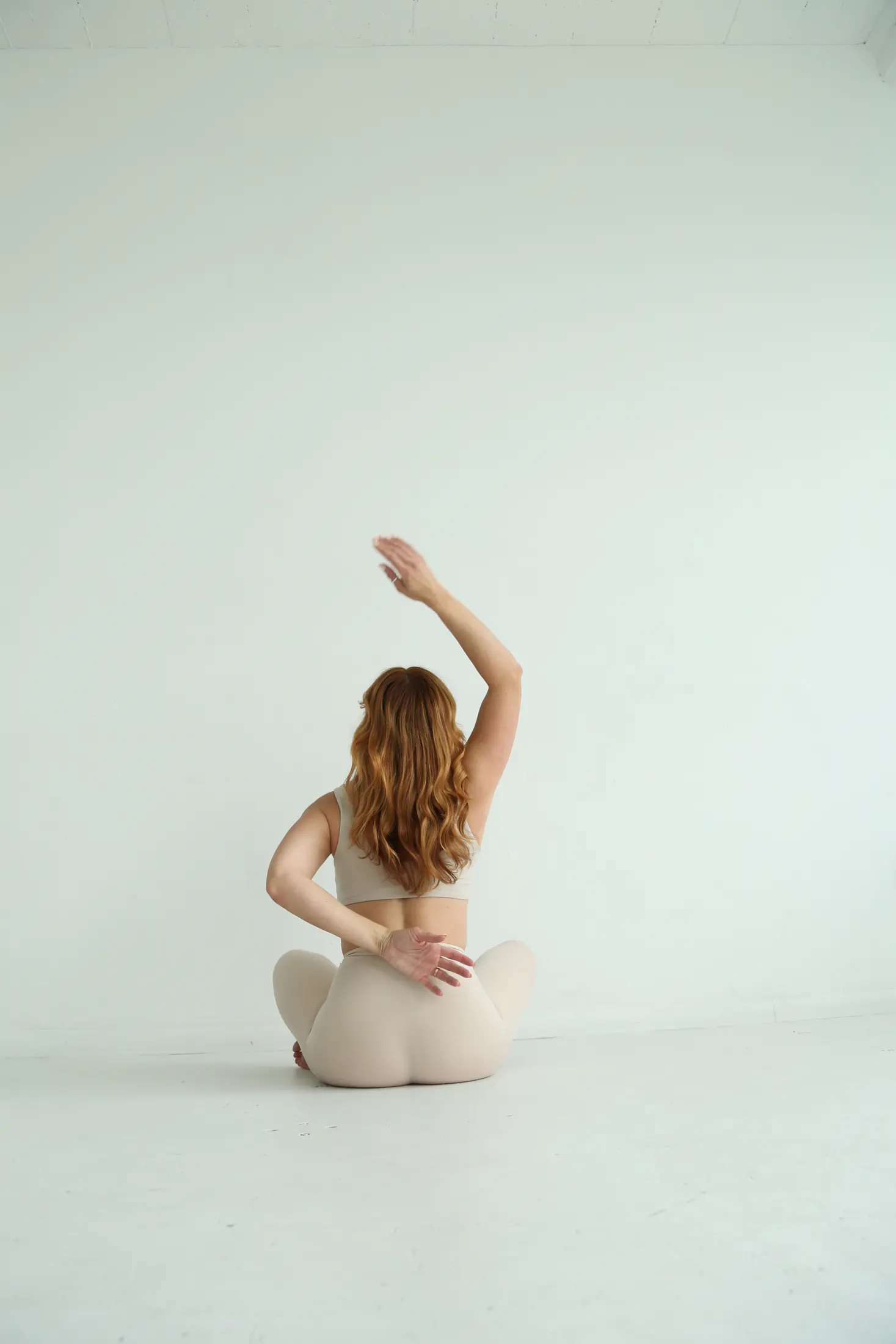 Shannon reaching through a seated side stretch